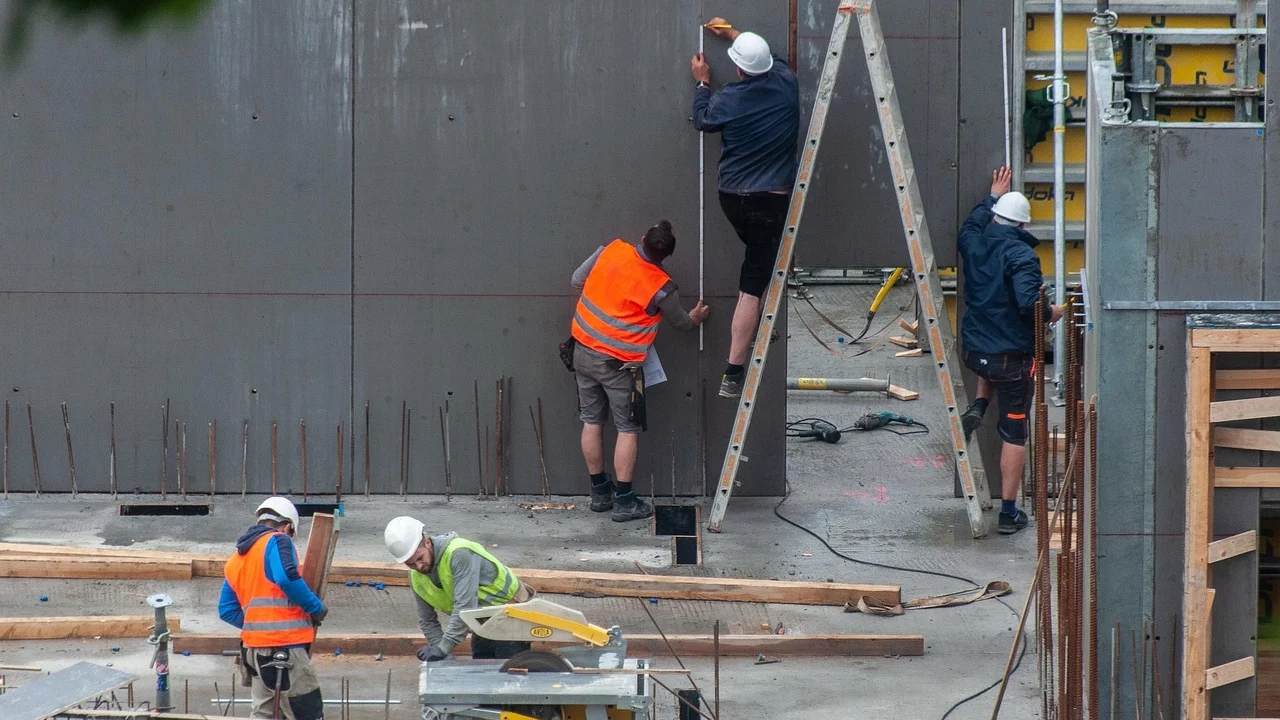 Construction workers operating on an active building site with safety equipment
