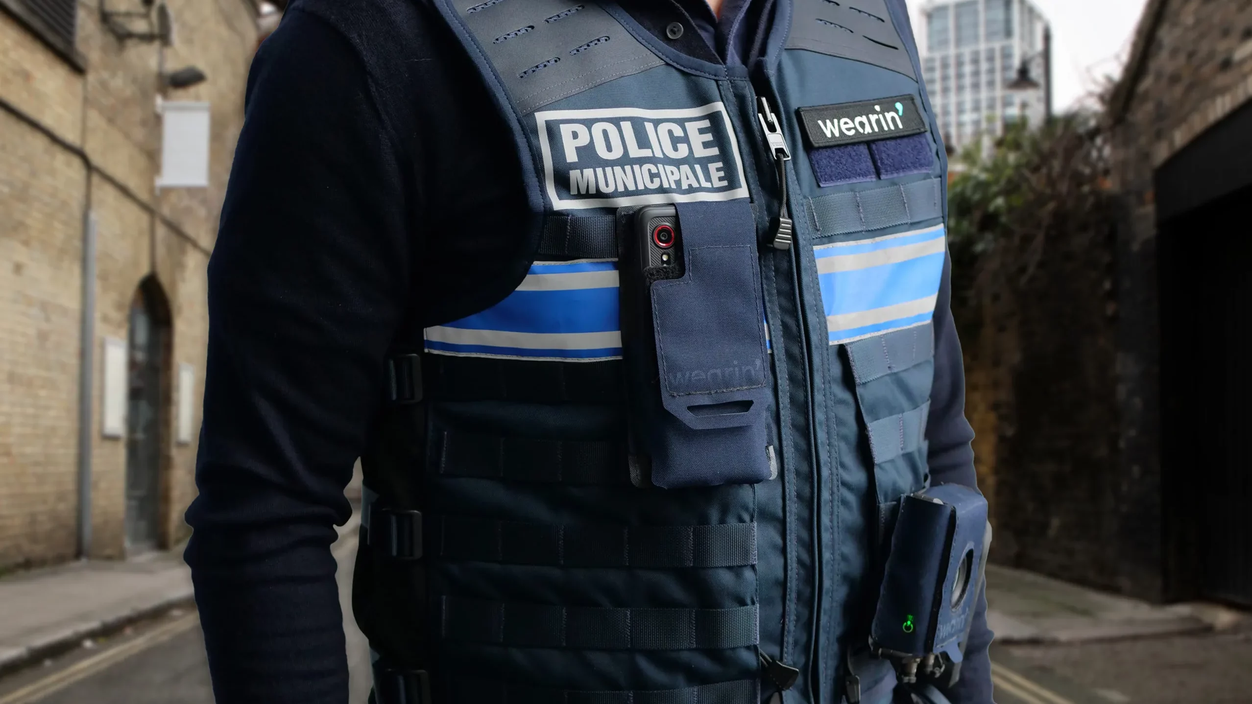 Law enforcement officer wearing an AccuRad PRD personal radiation detector during urban patrol