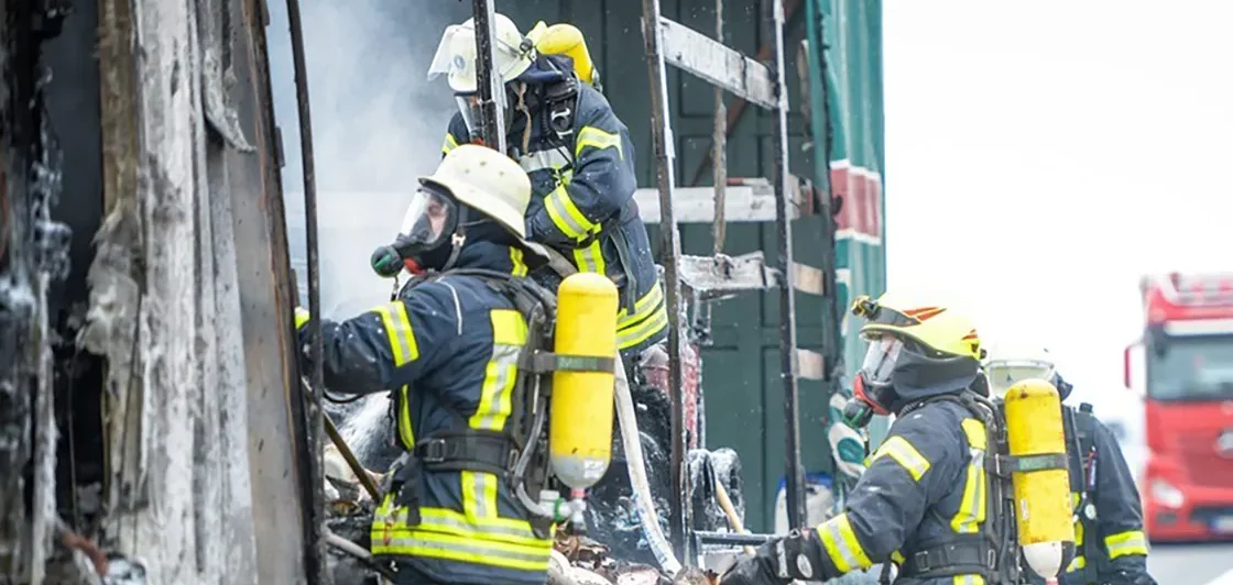 Firefighters in protective gear responding to an emergency with respiratory equipment